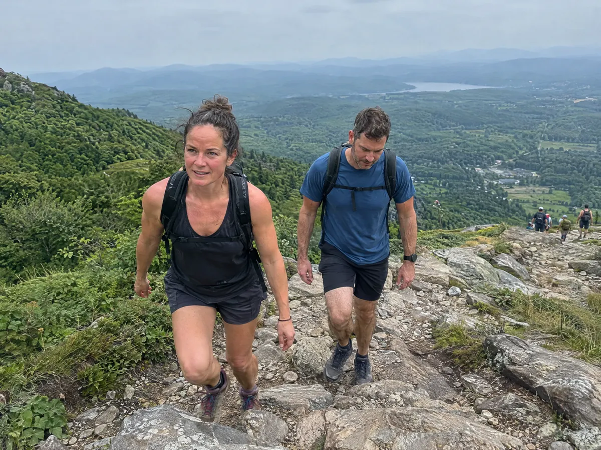 A couple hiking up a rocky trail